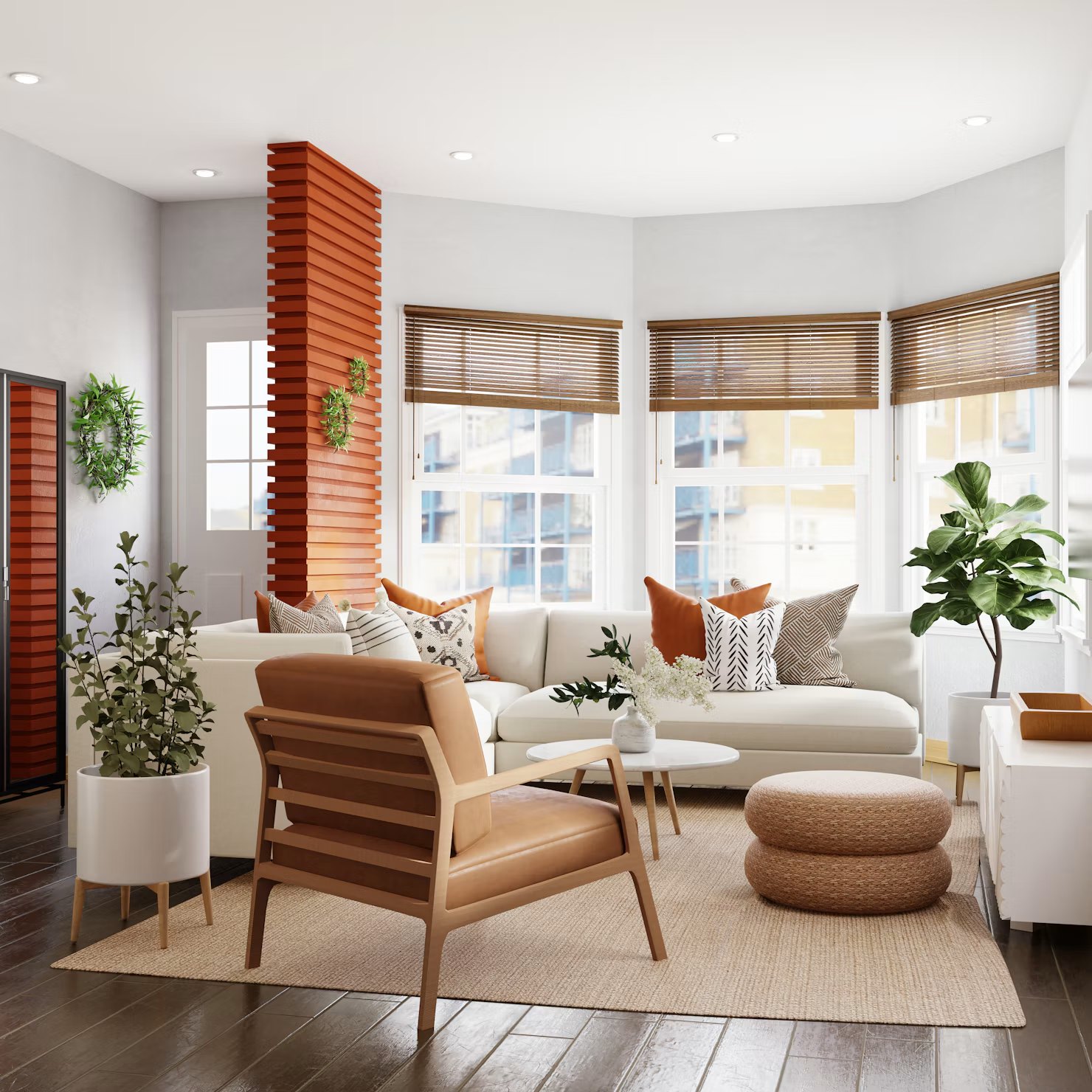 Bright living room with a cream sectional, a tan leather lounge chair, woven poufs and bay windows with wooden blinds